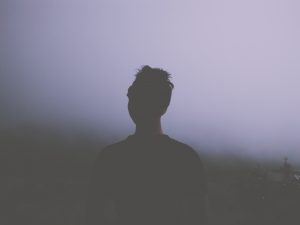 Silhouette of man standing in fog