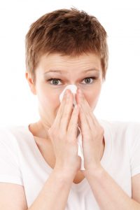 Woman blowing her nose