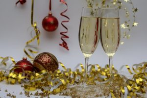 Two champagne glasses with ribbons and ornaents