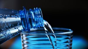 Water bottle pouring water into glass