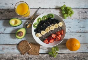 Fruit, veggies, toast, and orange juice on table