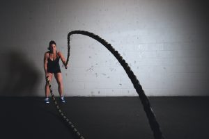 Woman with ropes at gym