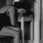 Nobody’s in the Mood for Low Sex Hormones Woman with head down in hand at a desk