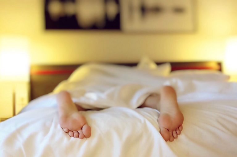 feet at the end of the bed indicating sleeping