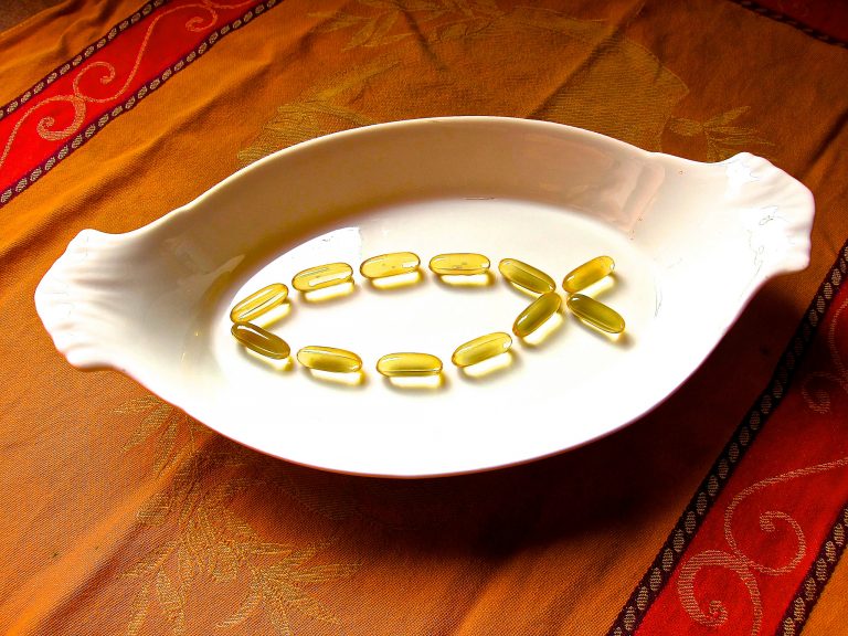 Dish with fish oil pills in shape of a fish