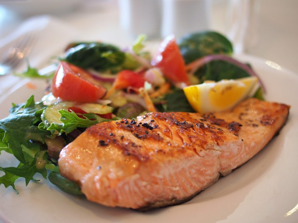 cooked salmon with a side of vegetables