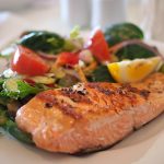 Here’s Exactly How Much Protein You Need to Lose Weight & Gain Muscle cooked salmon with a side of vegetables
