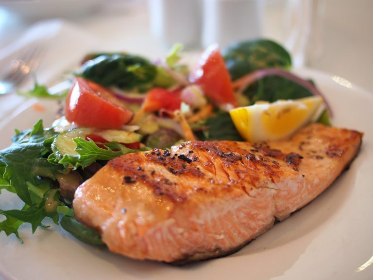 cooked salmon with a side of vegetables